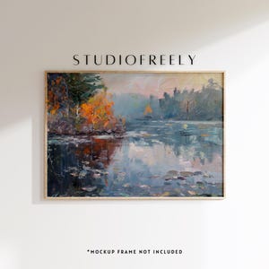 May include: An oil painting of a lake scene with trees in autumn colors. The artwork is framed in a light wood frame and features the text "STUDIOFREELY" at the top. The text "*MOCKUP FRAME NOT INCLUDED" is at the bottom.