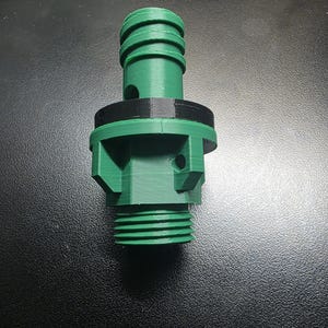 May include: A green and black 3D-printed connector with a threaded base and a ridged top. The connector has a cylindrical shape with a series of ridges and a black band around the middle. It is designed for connecting hoses or pipes.