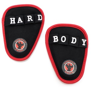 May include: A pair of black finger grips with red trim. The grips have white text that reads "HARD" and "BODY". The grips have a black and red logo that reads "GORILLA GRIPZ".