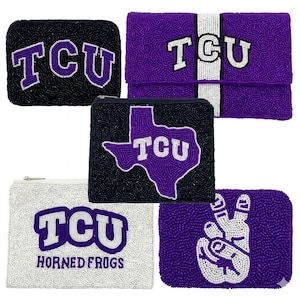 May include: A selection of beaded TCU Horned Frogs accessories. Includes a black clutch with the TCU logo, a purple clutch with a white stripe, and a white pouch with the words "Horned Frogs".