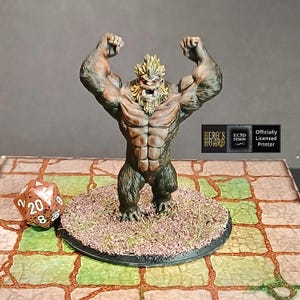 May include: A detailed miniature figurine of a muscular, humanoid creature with raised arms. The figure has a tan torso, brown fur, and a yellow mane. It stands on a circular base with faux grass. A twenty-sided die is in the foreground.