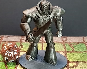 May include: A metallic gray figurine of an armored warrior holding a sword. The figure stands on a gray circular base, with a large twenty-sided die in the foreground. The background is a tabletop with a stone pattern.
