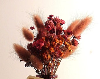 Bouquet of red/pink/orange dried flowers in a pretty decorative vase