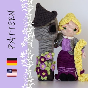 May include: A crocheted doll with long blonde hair and a purple dress standing next to a grey crocheted tower with purple flowers. The doll is holding a long blonde braid. The tower has a pointed roof and a window. The doll and tower are both handmade.