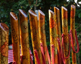 Handmade walking sticks made of wood and decorated with pyrography and painted