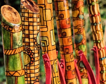 Handmade walking sticks made of wood and decorated with pyrography and painting