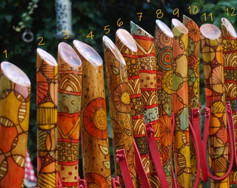 Handmade walking sticks made of wood and decorated with pyrography and painting