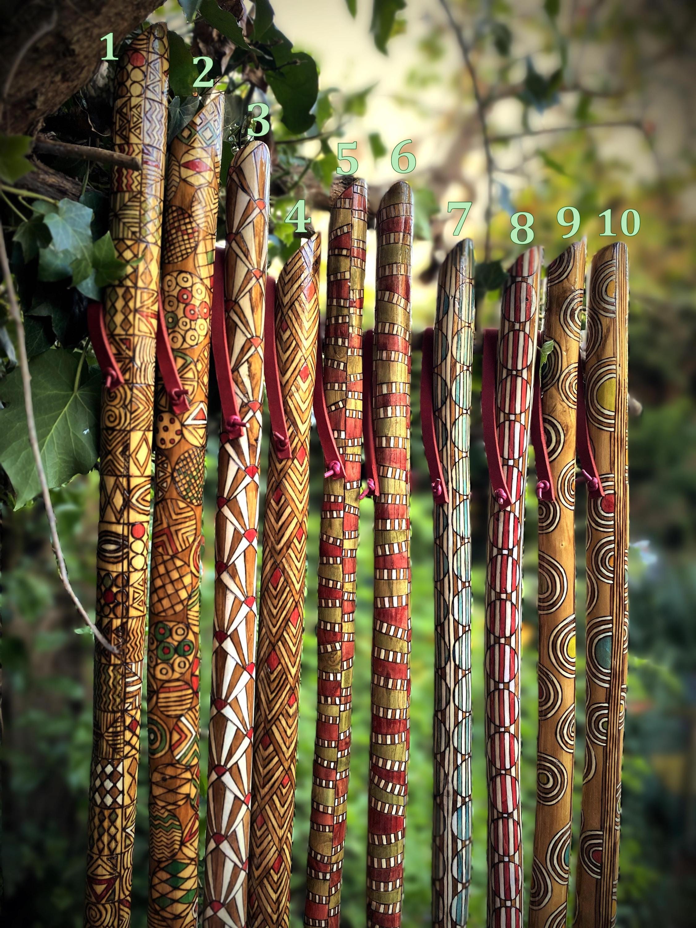 Handmade walking sticks made of wood and decorated with pyrography and painting