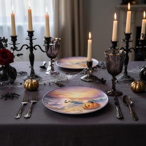 May include: A Halloween-themed table setting with a dark gray tablecloth. The table is decorated with gold pumpkins, black candelabras with lit candles, and plates with a ghost and pumpkin design. Silverware and purple goblets complete the festive look.