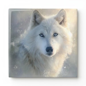 May include: Square art print featuring a close-up of a white wolf with piercing blue eyes. The wolf's fur is fluffy and detailed, set against a soft, blurred background. The artwork evokes a sense of serenity and the beauty of nature.