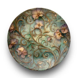 Puede incluir: Plato decorativo redondo con diseño floral. El plato presenta un fondo turquesa con vides y flores doradas en relieve en tonos morados y melocotón. El plato tiene una estética vintage y antigua.