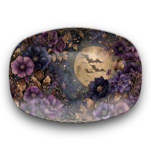 May include: Oval decorative plate with a watercolour design of a full moon, bats, and purple flowers. The floral arrangement includes dark blue and lavender blooms with gold accents, set against a dark blue and black background.