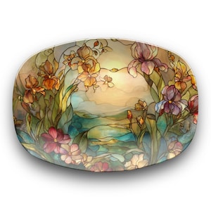 May include: Oval decorative plate with a stained-glass design. The plate features a floral landscape with irises in shades of orange, purple, and pink. The background depicts a serene landscape with a soft, warm color palette.