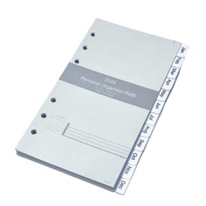 May include: A light gray personal organizer refill for 2026. The refill has a gray band with the text "Personal Organiser Refill" and month tabs. The tabs are labeled from January to December. The refill has a calendar and lines for notes.