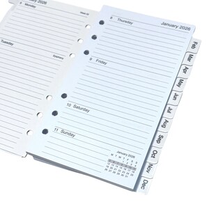 May include: A planner with lined pages for notes, featuring the days of the week and a calendar for January 2026. The planner includes monthly tabs and is designed for organization and scheduling.