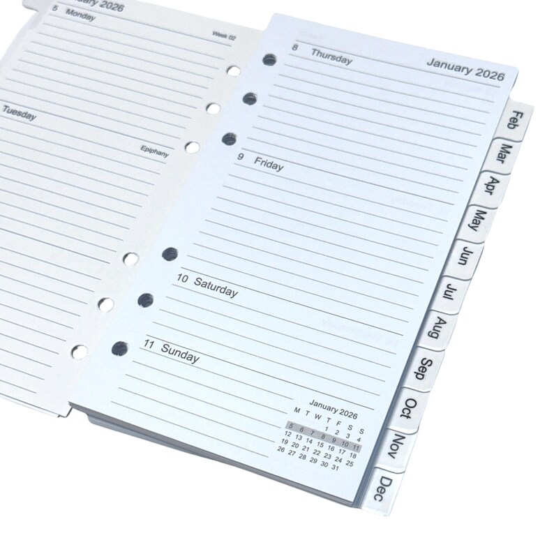 May include: A planner with lined pages for notes, featuring the days of the week and a calendar for January 2026. The planner includes monthly tabs and is designed for organization and scheduling.