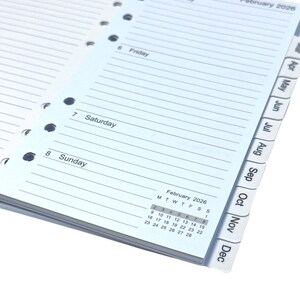 May include: Open planner pages with lined paper, showing the days of the week, including Friday, Saturday, and Sunday. The calendar for February 2026 is visible, along with monthly tabs. The pages have multiple holes for binding.
