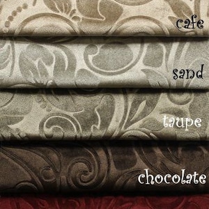 May include: Nine fabric swatches in various colors and patterns, including white, ivory, cafe, sand, taupe, chocolate, burgundy, gold, and navy. The fabric has a raised, embossed pattern.