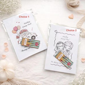 May include: Two wedding activity packs in clear plastic. One pack has a car with balloons and the text "Choice 1". The other pack has a bride and groom with the text "Choice 2". Each pack includes a small box of crayons.