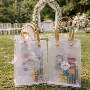 May include: Two clear tote bags with wooden handles and illustrations. One bag features a car with flowers and the text "Love". The other bag has a drawing of a couple and the text "Activity Box". Both bags contain crayons and toys.