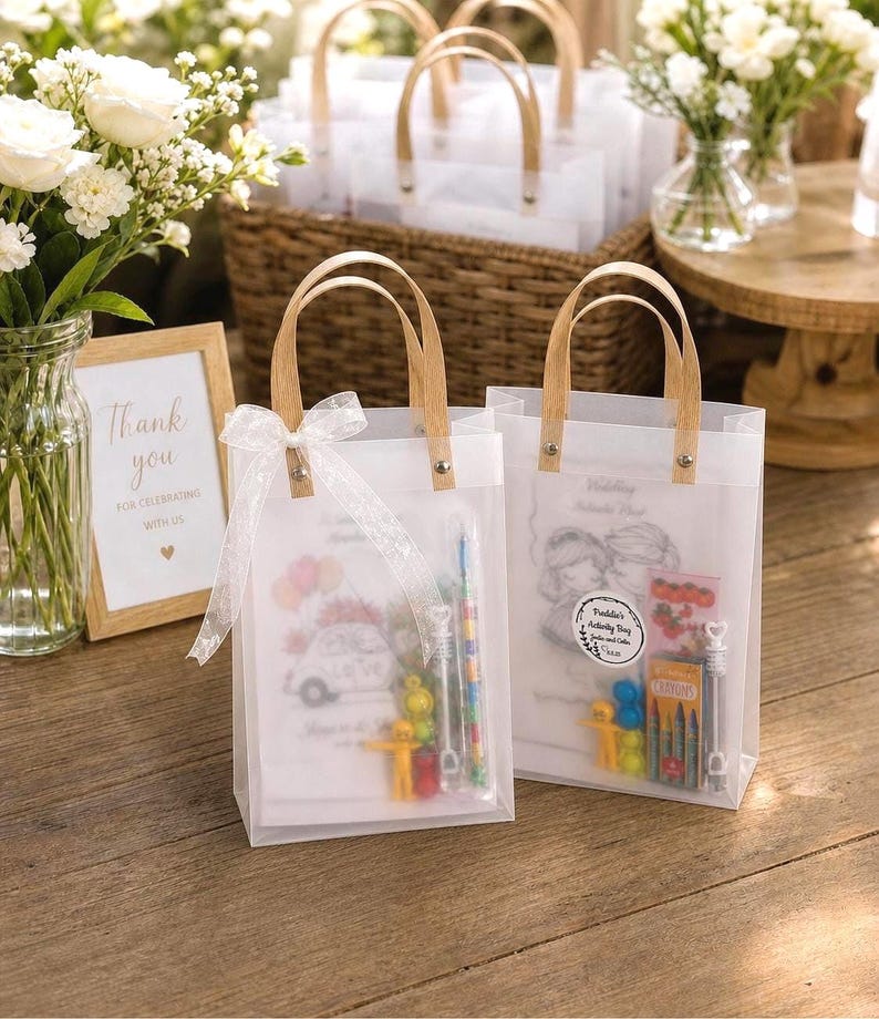 May include: Clear plastic tote bags with wooden handles, filled with small toys and crayons. The bags have a white ribbon and a printed design. A framed sign reads "Thank you".
