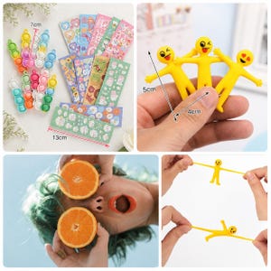 May include: A collection of colorful fidget toys, stickers, and yellow stretchy figures. The fidget toys are 7 cm long. The stickers are 13 cm long. The stretchy figures are 5 cm tall and 4 cm wide. The image is a collection of fun toys.