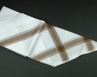 May include: White and brown patterned shemagh, a traditional Arab headscarf.