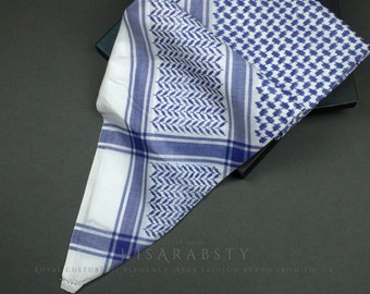 May include: A white and blue patterned keffiyeh, a traditional Arab headdress, folded in a triangular shape. The keffiyeh has a checkered pattern with blue and white stripes and a smaller blue and white geometric pattern.