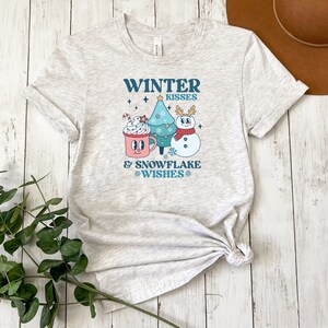 Winter Kisses & Snowflake Wishes Tee | Retro Holiday Hot Chocolate Shirt | Snowman and Christmas Tree Top | Festive Winter Apparel