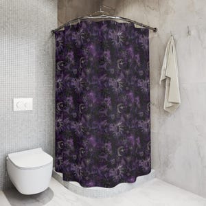 May include: Purple shower curtain featuring a celestial pattern of moons and suns. The pattern is in a gold colour and the background is a dark purple.