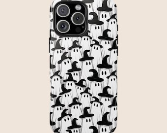May include: A white phone case featuring a repeating pattern of cartoon ghosts wearing black witch hats. The ghosts have simple, black dot eyes and are set against a white background. The case has a camera cutout.