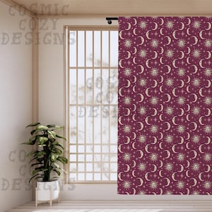 May include: Burgundy curtain with a repeating celestial pattern of suns, moons, and stars. The curtain hangs in front of a window, with the text "COSMIC COZY DESIGNS" visible on the left side. A potted plant sits in front of the window.