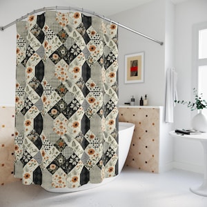 May include: A shower curtain with a patchwork design featuring floral, geometric, and solid patterns in black, white, and orange. The curtain is hanging in a bathroom with a white tub and a curved shower rod.