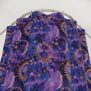 May include: Purple shower curtain with a gold celestial pattern featuring suns, moons, and stars.