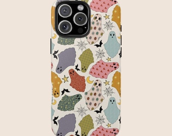 May include: A phone case featuring a repeating pattern of colorful ghosts, bats, spiderwebs, stars, and moons. The ghosts are in various colors and patterns, including orange, pink, blue, and green, set against a cream background. The case has a glossy finish.
