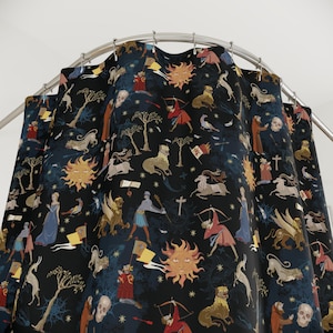 May include: A dark blue shower curtain featuring a repeating pattern of medieval figures, animals, suns, and trees. The design includes archers, lions, and winged creatures in shades of red, gold, and blue. The curtain hangs from a curved metal rail.