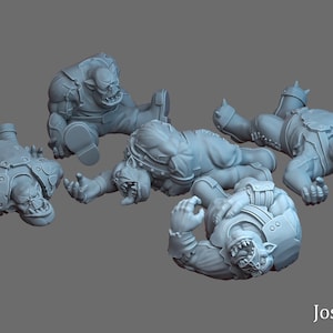 May include: A collection of five gray, 3D-printed orc miniatures in various poses. Each figure is detailed with armor and facial features, lying down on a gray surface. The image includes the text "JoshButIn3D".