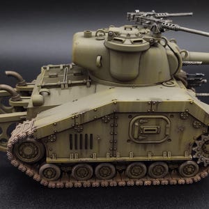 May include: A detailed model of a military tank, painted in shades of olive green and brown, with visible weathering effects. The tank features a large turret with machine guns and a long barrel, and is set against a dark background.