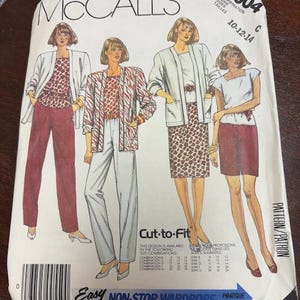 May include: A vintage McCall's sewing pattern packet featuring illustrations of women's clothing. The packet includes images of a blazer, pants, skirt, and top combinations. The text on the packet reads "Cut-to-Fit" and "Easy Non-Stop Wardrobe."