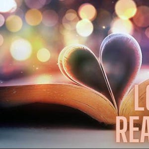 May include: An open book with its pages folded to form a heart shape. The text LOVE READING. is printed in a light peach color on the right side of the open pages. The background features soft, out-of-focus circular lights in warm tones.