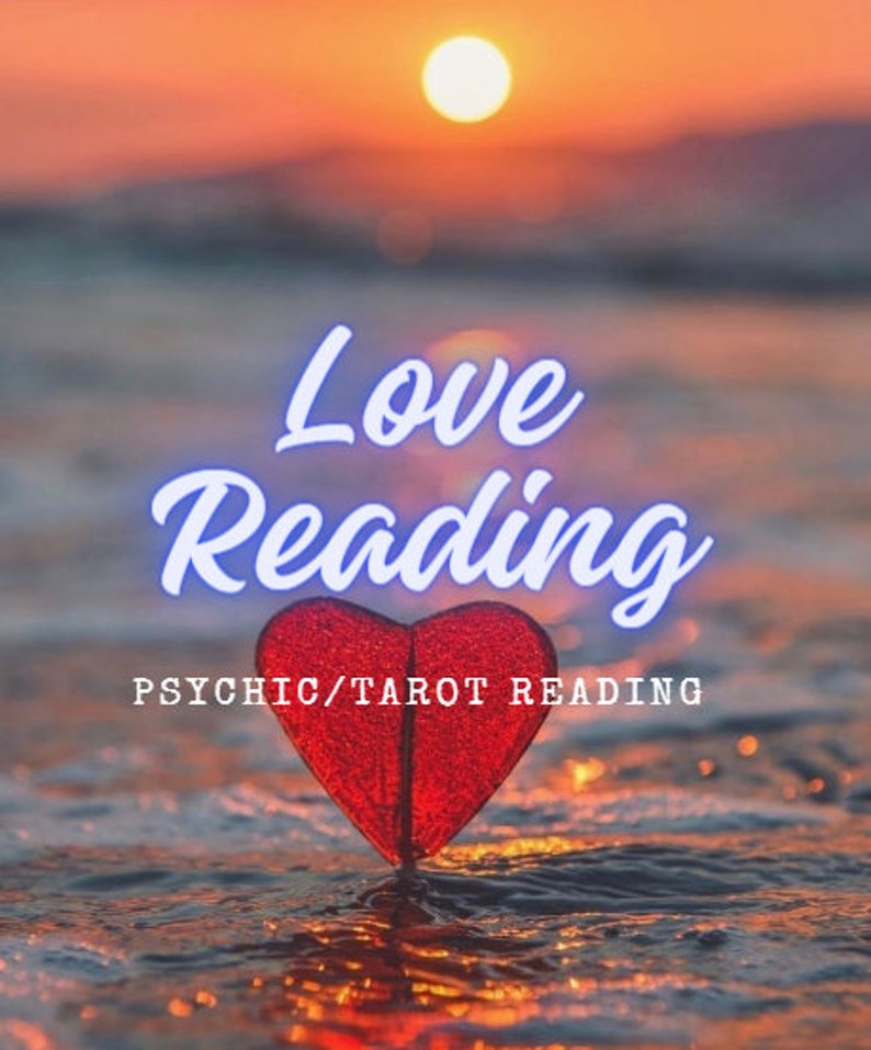 May include: A red heart-shaped object stands on a wet surface at sunset. The text "Love Reading" appears in white script above the heart, and the text "PSYCHIC/TAROT READING" is printed in white capital letters below the heart shape.