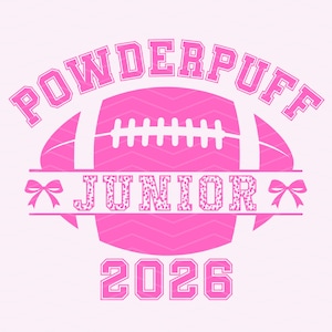 May include: Pink graphic design featuring the word "POWDERPUFF" arched above a football shape. Below the football is the word "JUNIOR" with a leopard print pattern, and the year "2026". Two bows flank the word "JUNIOR".