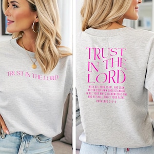 May include: Gray sweatshirt with the text "TRUST IN THE LORD" on the front and "TRUST IN THE LORD" with the Bible verse Proverbs 3:5-6 on the back, printed in pink.