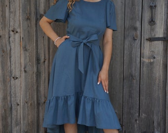 Linen dress Sea blue with pockets, low-high frill and in complete with a belt.