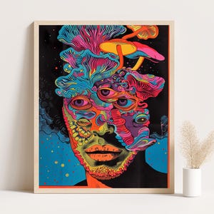 Pode incluir: Uma impressão artística emoldurada com um design psicodélico. A obra de arte retrata um rosto com múltiplos olhos e formas de cogumelos, usando cores vibrantes como rosa, azul, laranja e amarelo sobre um fundo preto. A impressão é emoldurada.