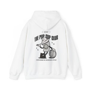 May include: White hooded sweatshirt with a black and gray graphic of a cartoon dog holding a pup cup. The text "JOIN TODAY! THE PUP CUP CLUB" and "IF YOU'RE READING THIS, YOUR DOG NEEDS A PUP CUP" is printed on the sweatshirt.