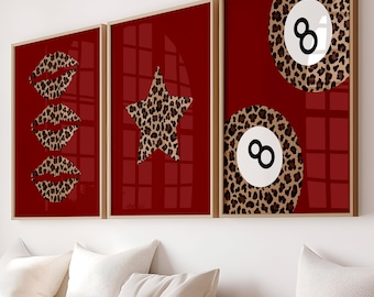 May include: Three framed art prints with a red background. One print features leopard print lips, another a leopard print star, and the last two leopard print 8-ball designs. The frames are a light wood color.