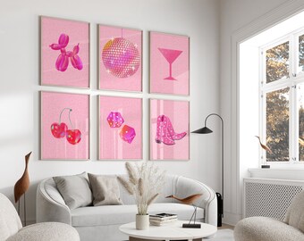 May include: A set of six pink framed prints with various images, including a disco ball, a martini glass, a pair of cowboy boots, a balloon animal, cherries, and dice. The prints are hanging on a white wall in a living room setting.