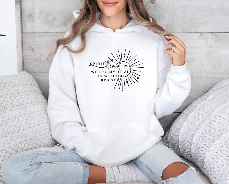 May include: White hoodie with a black graphic that says "Spirit lead me where my trust is without borders".
