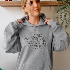 May include: A gray hooded sweatshirt with a black graphic print that reads "Spirit lead me where my trust is without borders".